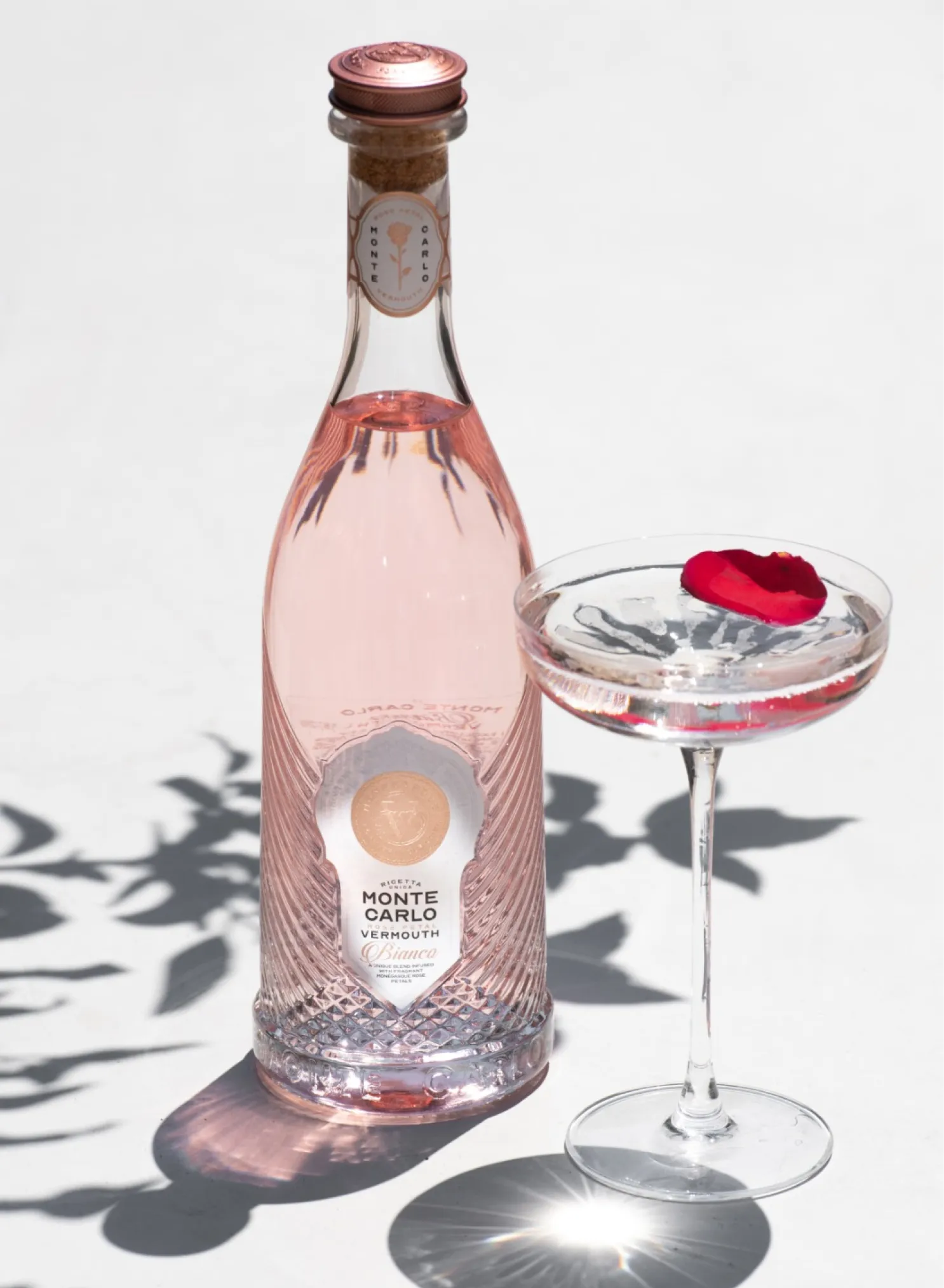 A bottle of Monte Carlo Vermouth Bianco next to a spritz.